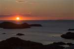 Sunset over Berneray and Barra from Coll